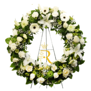 Corona mixta de flores frescas con atril, compuesta por rosas, lirios, claveles y margaritas, ideal para ceremonias de homenaje y tributos florales